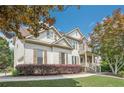 Beautiful two-story home showcasing stone accents, shutters, and manicured lawn at 113 Gold Bridge Xing, Canton, GA 30114