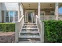 Inviting front entrance with stone stairs, detailed stonework, and a glass-paneled front door at 113 Gold Bridge Xing, Canton, GA 30114