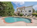 Resort-style backyard with a sparkling pool, spacious patio, and lush landscaping at 113 Gold Bridge Xing, Canton, GA 30114