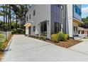 Side view of a modern two-story home with gray siding and large sliding glass doors at 1554 Columbia Cir, Decatur, GA 30032
