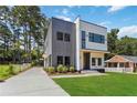 Modern two-story home with gray and white siding, black trim windows, and manicured front yard at 1554 Columbia Cir, Decatur, GA 30032