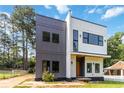 Contemporary two-story home with unique gray and white siding, complemented by black-framed windows at 1554 Columbia Cir, Decatur, GA 30032