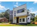 Modern residence showcasing a distinctive exterior with clean lines, expansive windows, and contrasting siding at 1554 Columbia Cir, Decatur, GA 30032