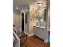 Stylish bar area with sleek cabinets, mosaic tile backsplash, and decorative art at 1984 Mendenhall Cir, Atlanta, GA 30341