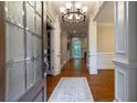 Elegant foyer with hardwood floors, a decorative rug, and detailed molding throughout at 1984 Mendenhall Cir, Atlanta, GA 30341