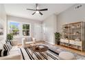 Bright living room featuring a ceiling fan, modern furniture, and natural light from large windows at 340 Bell Se St, Marietta, GA 30060
