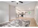Bright, open-concept living area featuring wood floors, neutral walls, and seamless flow into modern, white-cabinet kitchen at 340 Bell Se St, Marietta, GA 30060