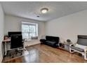 Bright room with hardwood floors and a large window offering natural light, complete with a desk and futon at 1133 Capital Club Ne Cir, Brookhaven, GA 30319