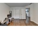 A cozy room featuring hardwood floors, with double closets and a doorway into the next room at 1133 Capital Club Ne Cir, Brookhaven, GA 30319
