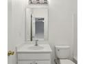 Simple bathroom with white walls, white vanity, and toilet at 5126 Wellsley Bnd, Alpharetta, GA 30005