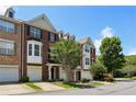 Corner view of a brick townhome with a two-car garage at 5126 Wellsley Bnd, Alpharetta, GA 30005