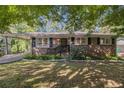 Beautiful brick home with a covered parking and a well-maintained lawn at 863 Needle Rock Dr, Stonecrest, GA 30083