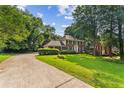 Traditional brick home featuring a spacious front lawn and private driveway at 3878 Brookside Pkwy, Decatur, GA 30034