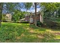 Traditional red brick home with lush lawn, landscaping, and mature trees at 3878 Brookside Pkwy, Decatur, GA 30034