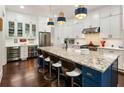 Gourmet kitchen features a large granite island, stainless appliances, and custom white cabinets at 4010 Cameron Ct, Cumming, GA 30040