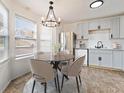 Bright eat-in kitchen features stainless steel appliances, modern cabinets, a chandelier, and lots of natural light at 3775 Reston Ln, Decatur, GA 30034