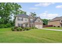 Lovely two-story home with a two-car garage and a beautifully landscaped front yard at 397 Victory Ln Ln, Locust Grove, GA 30248