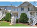 Rear exterior featuring a private back porch, well-maintained lawn and mature landscaping at 620 Neel Reid Dr, Roswell, GA 30075