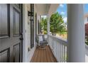 Inviting front porch featuring chair seating and an attractive black front door at 620 Neel Reid Dr, Roswell, GA 30075