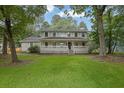 Inviting home with a spacious front yard and a welcoming covered porch at 2055 Pinella Dr, Grayson, GA 30017