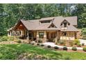 Lovely home featuring mature landscaping, inviting covered porch, stone detailing, and a well-manicured lawn at 2149 Batesville Rd, Canton, GA 30115