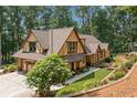 Beautiful exterior elevation of a home showing its impeccable landscaping, architectural details, and three-car garage at 2149 Batesville Rd, Canton, GA 30115