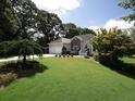 Beautiful home boasts a lush green lawn and mature landscaping, creating a serene curb appeal at 5 Glenn Eagles Vw, Hiram, GA 30141