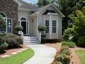 Inviting entrance showcases a stone-accented facade and a walkway surrounded by manicured greenery at 5 Glenn Eagles Vw, Hiram, GA 30141