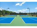 Two tennis courts at a neighborhood athletic facility on a clear day at 5330 Keepsake Court, Cumming, GA 30040