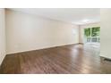 Spacious living room boasts hardwood floors and a sliding glass door leading to the outside at 6192 Holiday Blvd, Forest Park, GA 30297