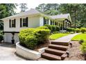 Charming home with a beautiful brick pathway and lush landscaping, adding to its appeal at 3548 Liberty Ln, Marietta, GA 30062