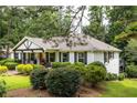 Beautiful home featuring a well-maintained lawn and mature trees, offering a serene setting at 3548 Liberty Ln, Marietta, GA 30062