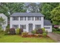 Inviting home featuring a well-maintained lawn, traditional design, and attached one car garage at 6338 Boyett Dr, Norcross, GA 30093