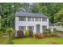Beautiful two-story home boasts mature trees, manicured landscaping, and classic architectural design at 6338 Boyett Dr, Norcross, GA 30093