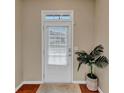 Bright entryway featuring a white front door with glass insert and a potted plant at 1936 Lakeshore Overlook Circle Nw Cir, Kennesaw, GA 30152