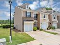 Attractive townhome featuring a one-car garage, well-maintained landscaping, and inviting curb appeal at 1936 Lakeshore Overlook Circle Nw Cir, Kennesaw, GA 30152