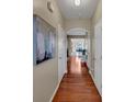 Inviting hallway with gleaming hardwood floors leading to a dining area and other rooms at 1936 Lakeshore Overlook Circle Nw Cir, Kennesaw, GA 30152