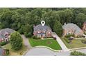 Beautiful aerial shot of a classic brick home surrounded by mature trees at 2145 Sugarstone Ct, Lawrenceville, GA 30043