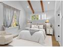 Serene bedroom with soft lighting, beamed ceilings, and neutral decor for a relaxing retreat at 407 Westside Dr, Roswell, GA 30075