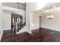 Open-concept foyer featuring hardwood floors, staircase, and view of the dining room with decorative ceilings at 7790 Stratford Ln, Atlanta, GA 30350