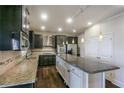 Spacious kitchen with granite countertops, stainless steel appliances, and dark wood cabinetry at 7790 Stratford Ln, Atlanta, GA 30350