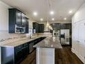 Spacious kitchen with granite countertops, stainless steel appliances, and dark wood cabinetry at 7790 Stratford Ln, Atlanta, GA 30350