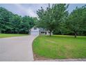 Inviting home featuring an attached garage and a long driveway on a lush green lawn at 40 Heather Woods Ct, Covington, GA 30016