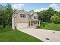 Two-story home featuring a brick and siding exterior, a spacious driveway, and a green lawn at 5662 Valley Loop, Fairburn, GA 30213