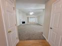 Spacious living room boasts a fireplace, neutral carpet, and abundant natural light from large windows at 983 Noble Oak Ct, Lawrenceville, GA 30046