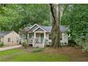 Quaint home featuring a well-manicured lawn and a spacious yard with mature trees at 1735 Jobeth Se Ave, Atlanta, GA 30316