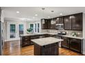 Well-equipped kitchen boasting dark wood cabinets, a granite island, and stainless steel appliances at 1735 Jobeth Se Ave, Atlanta, GA 30316