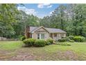 Single-story house featuring a bay window, front porch, and a yard at 1904 Britt Dr, Snellville, GA 30078