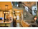 Warm entryway with hardwood floors, staircase with iron railing, decor, and kitchen with a breakfast bar at 1951 Barrett Knoll Nw Cir, Kennesaw, GA 30152