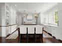 Bright kitchen featuring double islands, modern fixtures, and custom cabinetry at 6440 Westchester Pl, Cumming, GA 30040